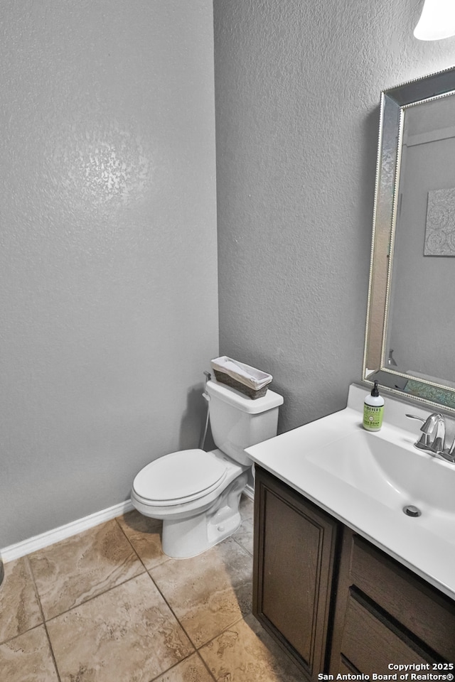 bathroom featuring toilet and vanity