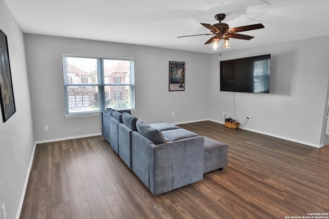 living room with ceiling fan and dark wood-type flooring