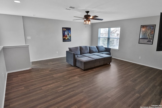 living room featuring ceiling fan and dark hardwood / wood-style flooring