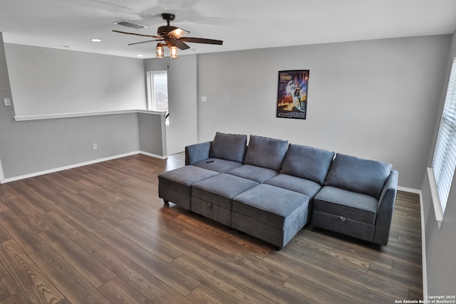 living room featuring ceiling fan and dark hardwood / wood-style flooring