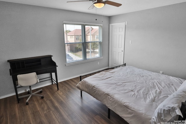 bedroom featuring dark hardwood / wood-style floors and ceiling fan