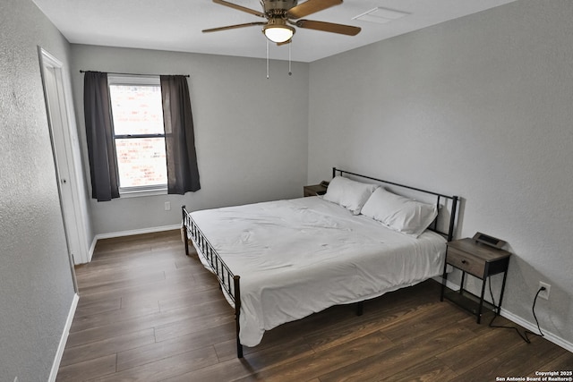 bedroom featuring ceiling fan and dark hardwood / wood-style floors