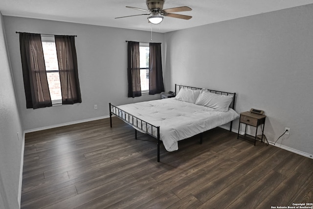 bedroom with ceiling fan and dark wood-type flooring