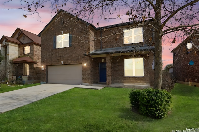 view of front of home featuring a garage and a yard