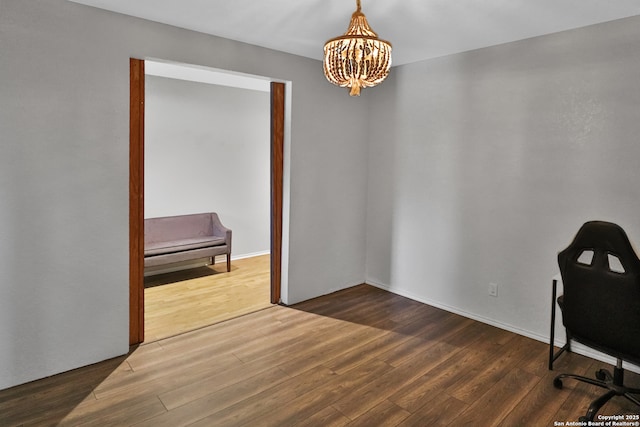 office area with a notable chandelier and dark wood-type flooring