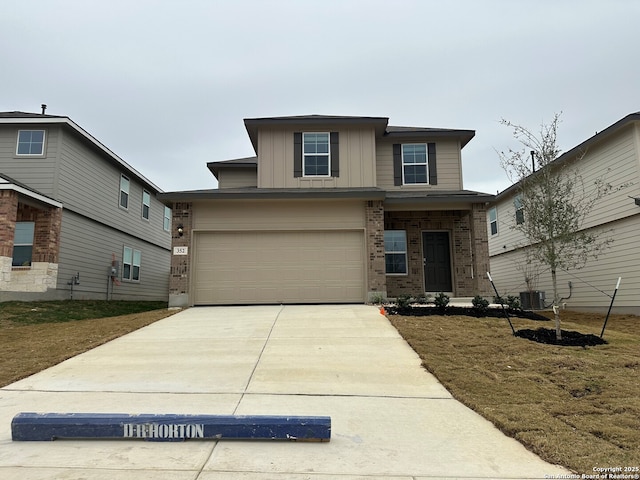 view of front of property with a garage and cooling unit