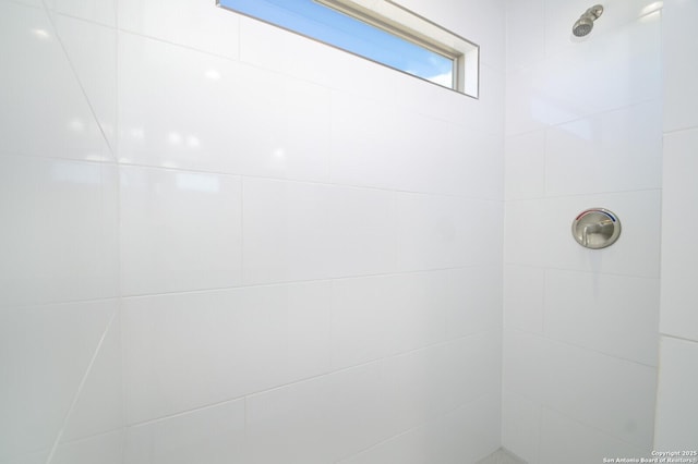 bathroom with tiled shower