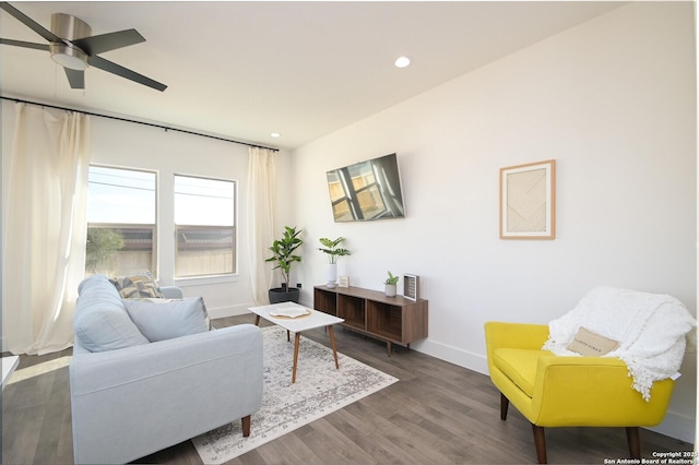 living room featuring dark hardwood / wood-style flooring and ceiling fan