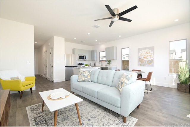 living room featuring light hardwood / wood-style floors and ceiling fan