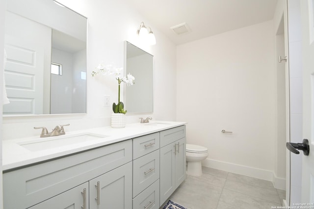 bathroom with vanity, tile patterned flooring, and toilet