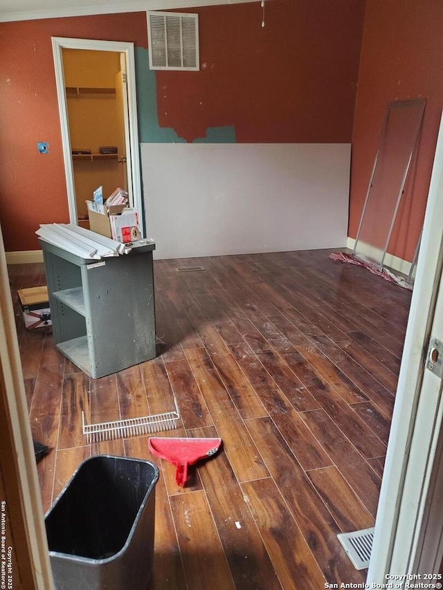 interior space with dark wood-style flooring and visible vents