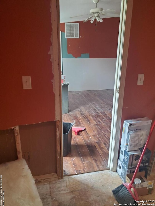 hall featuring visible vents and wood finished floors