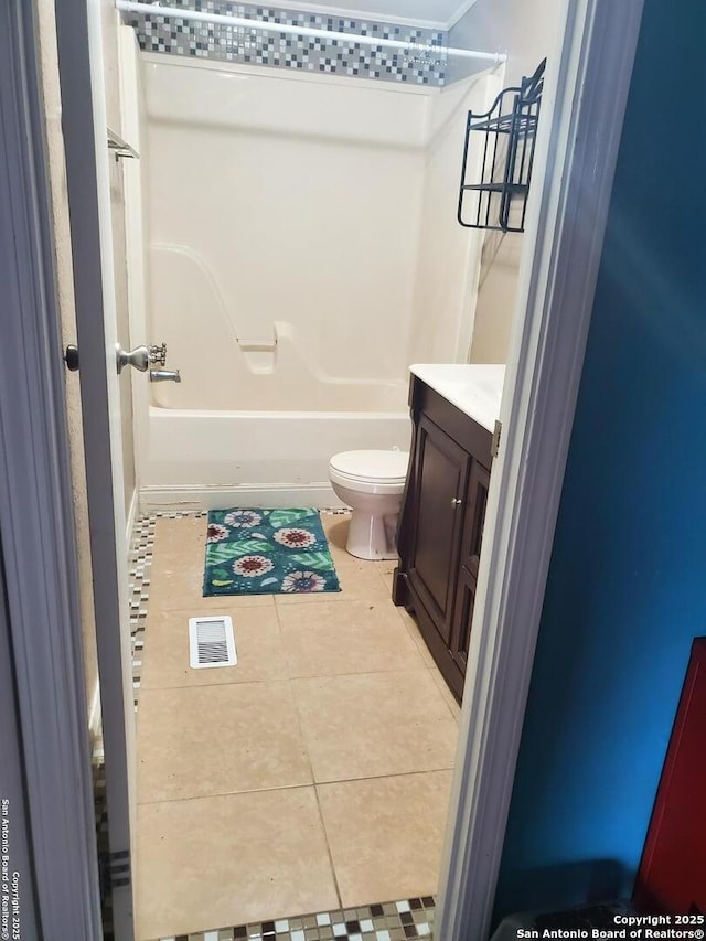 bathroom featuring shower / bathtub combination, visible vents, toilet, vanity, and tile patterned floors