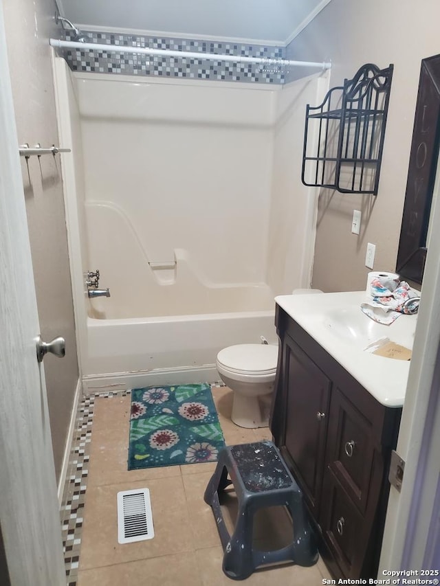 full bathroom with visible vents, toilet, vanity,  shower combination, and tile patterned flooring