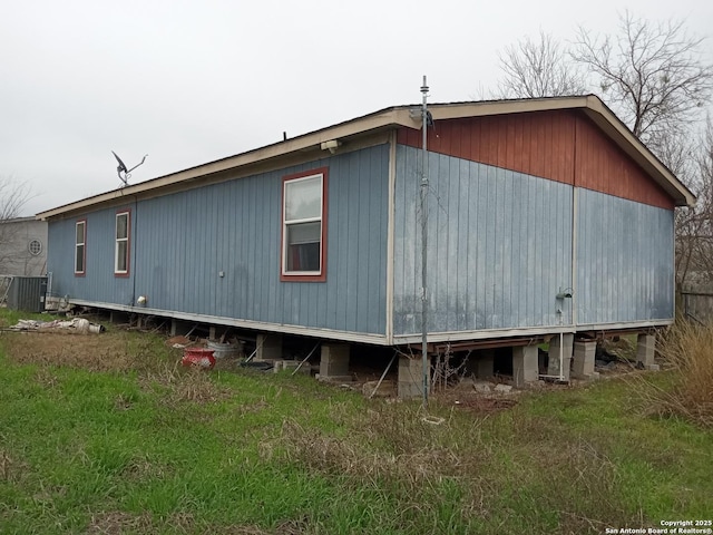 view of side of home with central AC unit