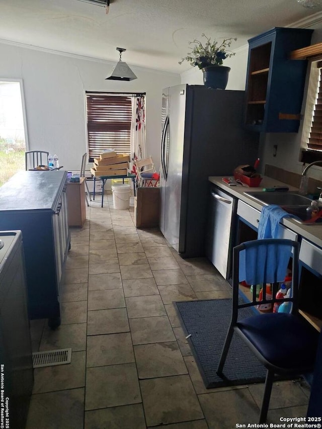 kitchen with a sink, hanging light fixtures, blue cabinetry, dishwasher, and open shelves