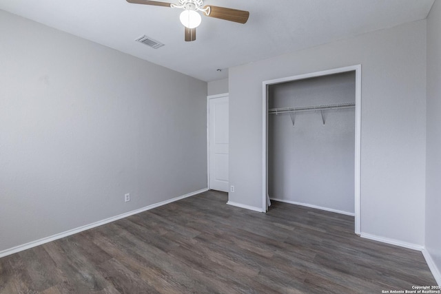 unfurnished bedroom with ceiling fan, a closet, and dark hardwood / wood-style flooring