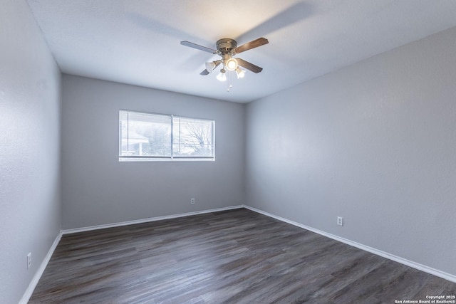 empty room featuring ceiling fan and dark hardwood / wood-style flooring