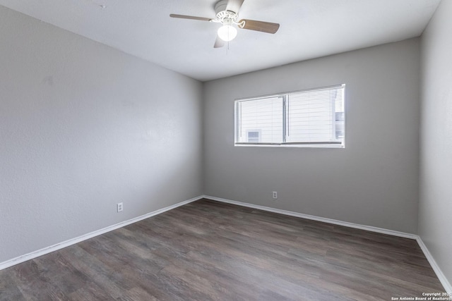 spare room featuring ceiling fan and dark hardwood / wood-style floors