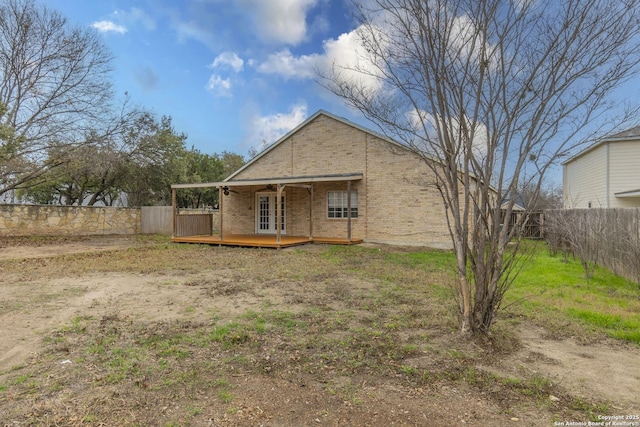 back of property with a wooden deck