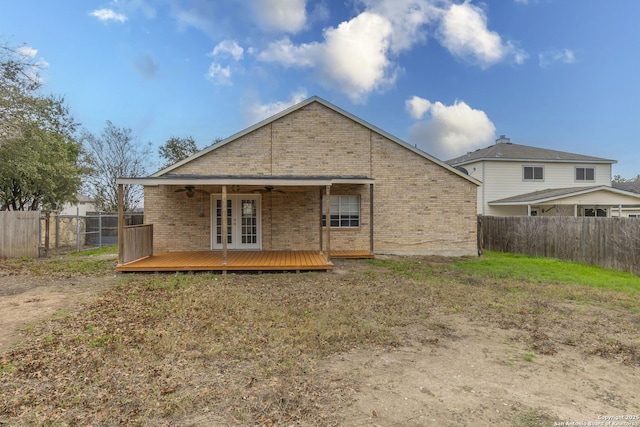 back of house featuring a deck, a lawn, and ceiling fan