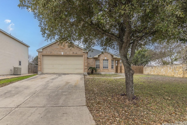 ranch-style home with central AC and a garage