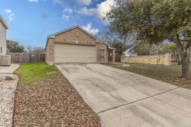 view of front facade featuring a front yard, central AC unit, and a garage