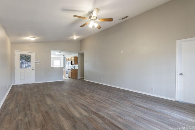 unfurnished living room featuring ceiling fan, vaulted ceiling, and dark wood-type flooring