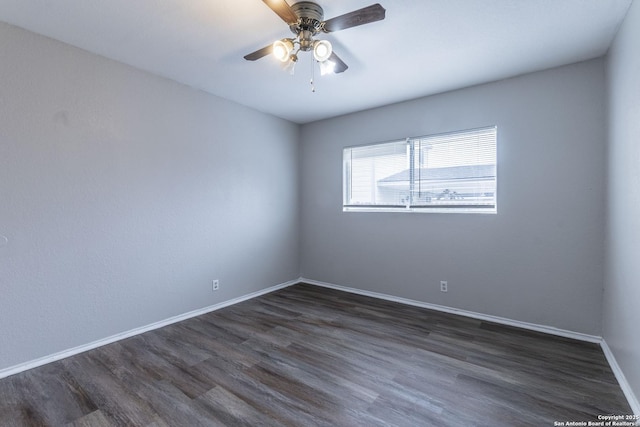 spare room with ceiling fan and dark hardwood / wood-style flooring