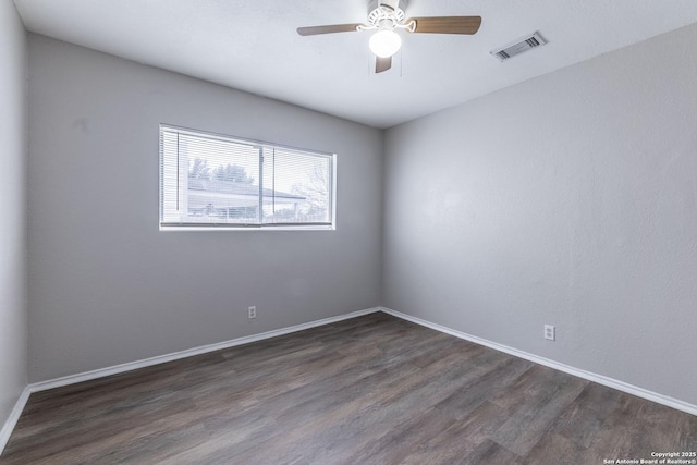 unfurnished room with dark hardwood / wood-style flooring and ceiling fan