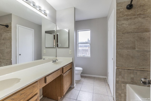 bathroom featuring vanity, toilet, tile patterned floors, and a tub to relax in