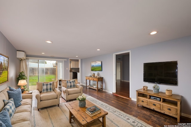 living room featuring dark wood-type flooring and a wall mounted air conditioner