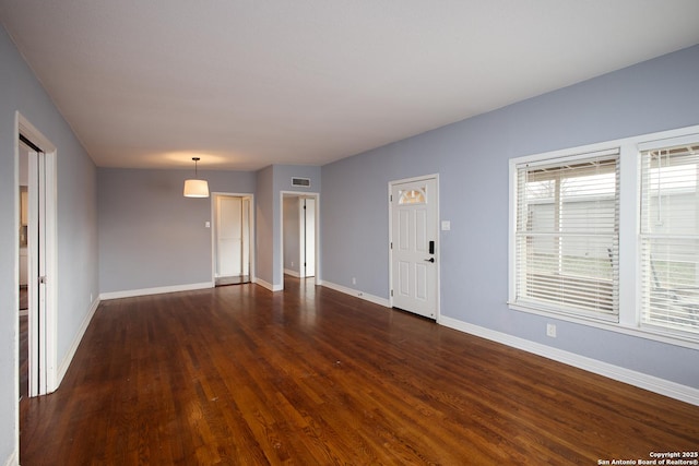 unfurnished living room with dark hardwood / wood-style floors