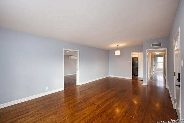 unfurnished room featuring dark hardwood / wood-style flooring