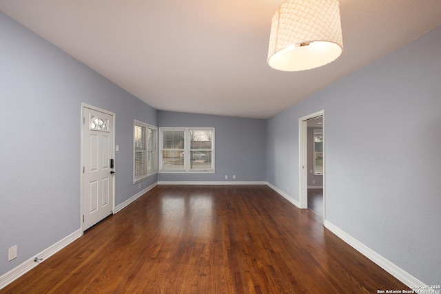 unfurnished room with dark wood-type flooring