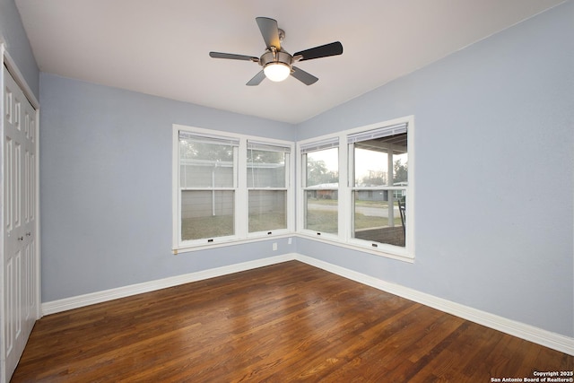 unfurnished bedroom featuring a closet, dark wood-type flooring, and ceiling fan