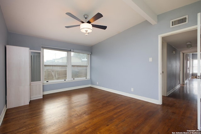 empty room featuring ceiling fan, dark wood-type flooring, and lofted ceiling with beams