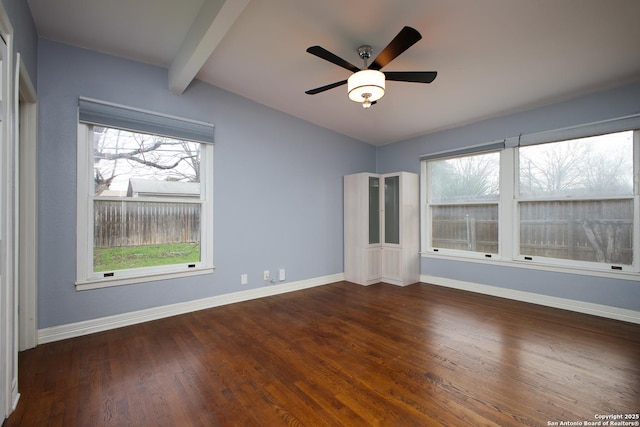 empty room featuring ceiling fan, vaulted ceiling with beams, and dark hardwood / wood-style flooring