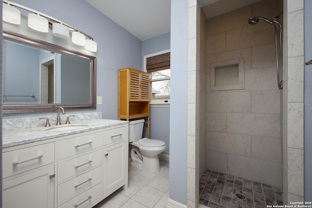 bathroom featuring toilet, tiled shower, tile patterned flooring, and vanity