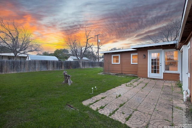 yard at dusk with a patio