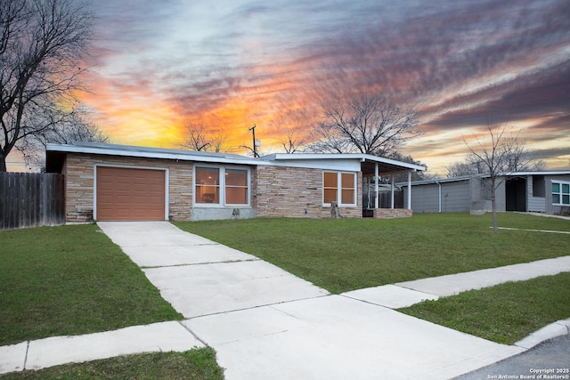 view of front of home with a yard and a garage