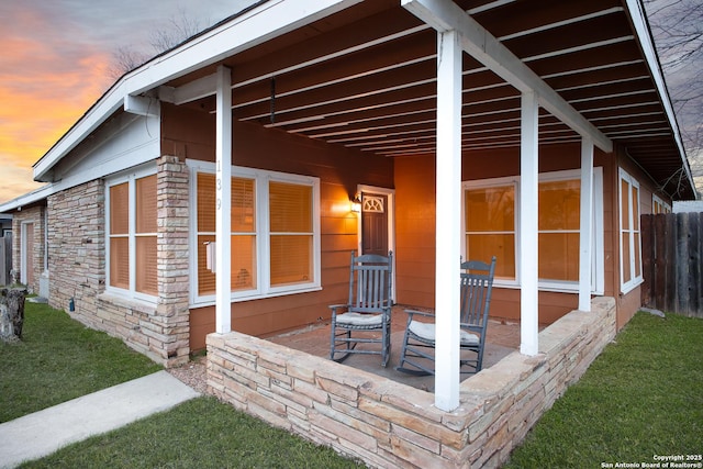 property exterior at dusk featuring a patio area