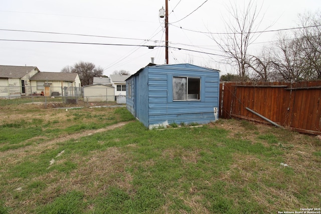 view of outdoor structure featuring a lawn