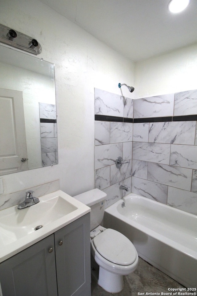 full bathroom featuring toilet, vanity, and tiled shower / bath combo