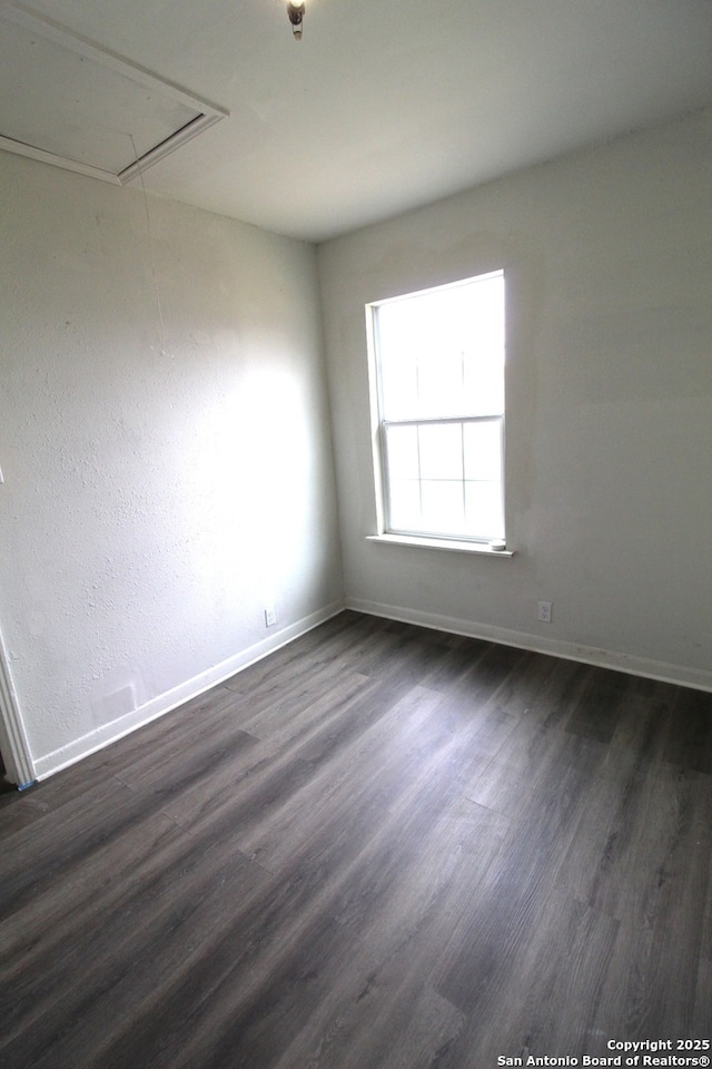 spare room featuring dark hardwood / wood-style flooring