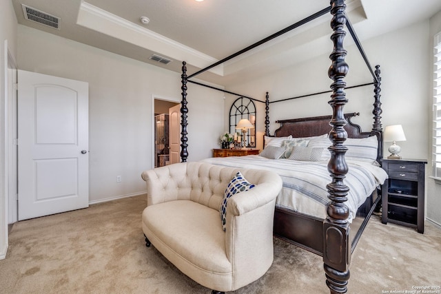 carpeted bedroom with ornamental molding, visible vents, and ensuite bath