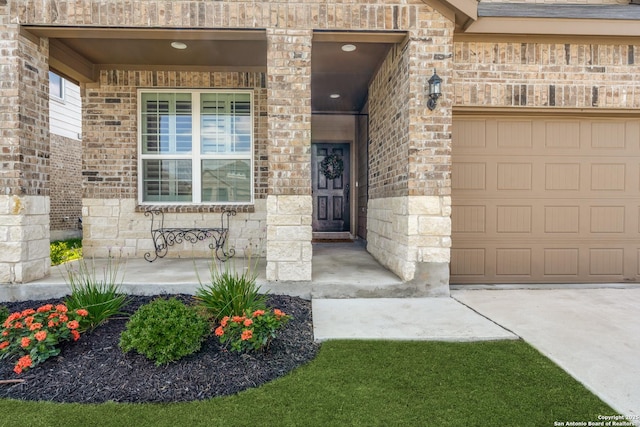 doorway to property featuring brick siding and an attached garage