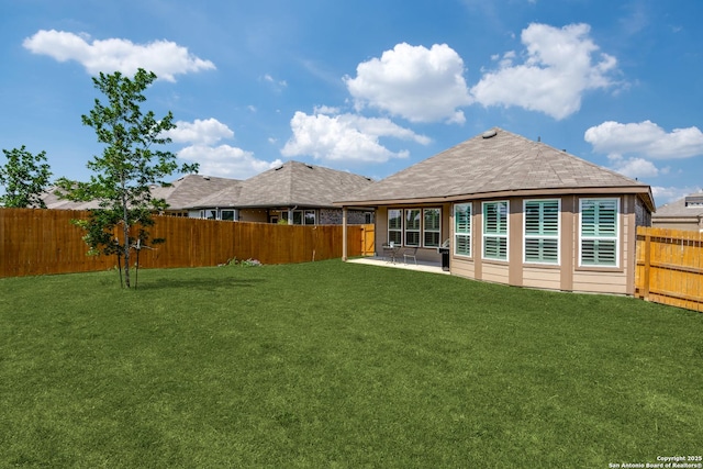 rear view of property featuring a patio area, a fenced backyard, and a yard