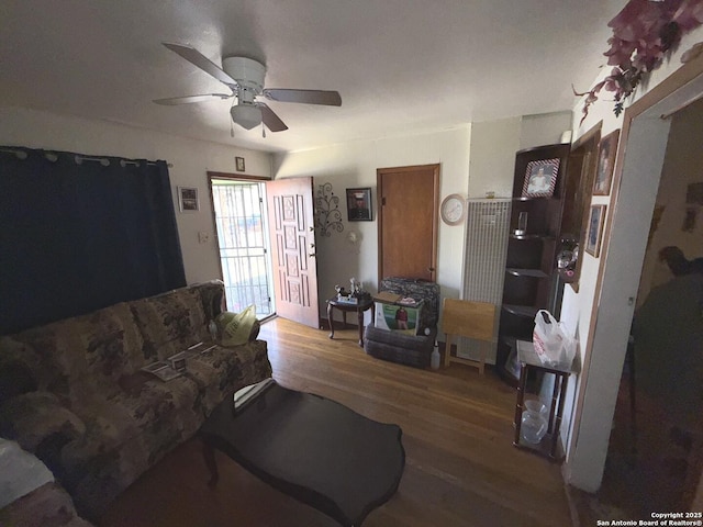 living room with hardwood / wood-style flooring and ceiling fan