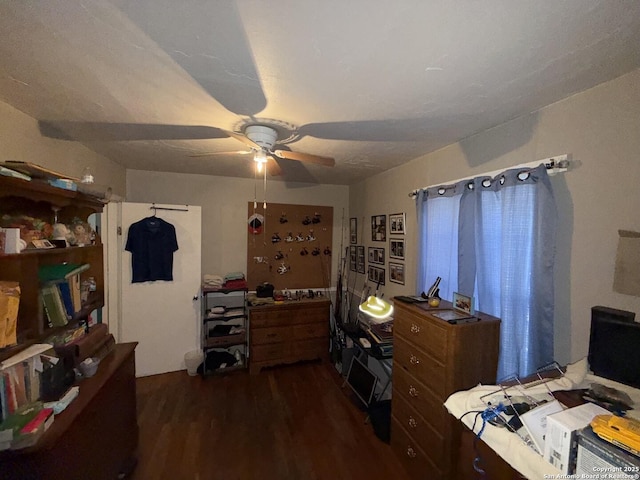 bedroom with ceiling fan and dark hardwood / wood-style flooring